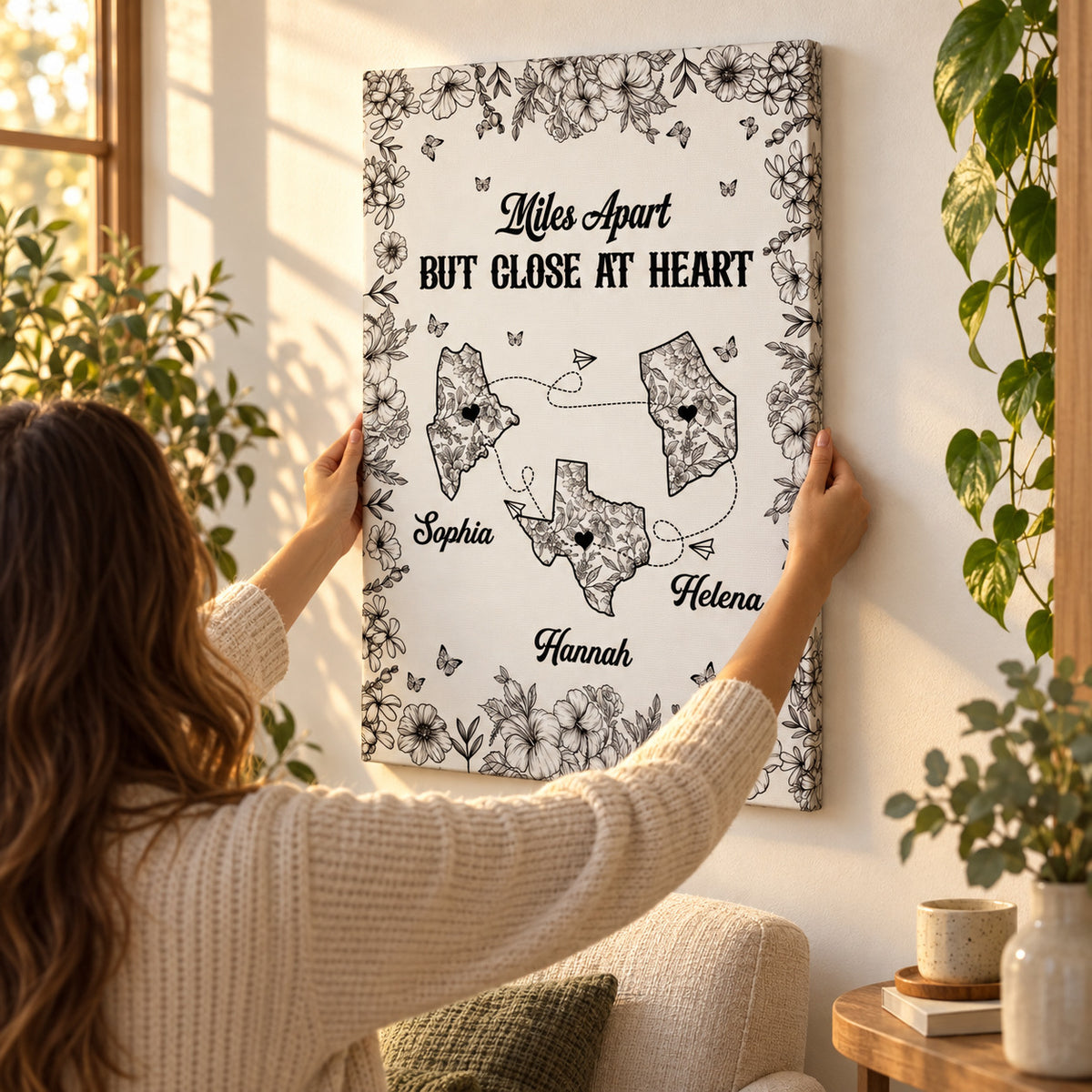 Hands straightening the personalized canvas on the wall